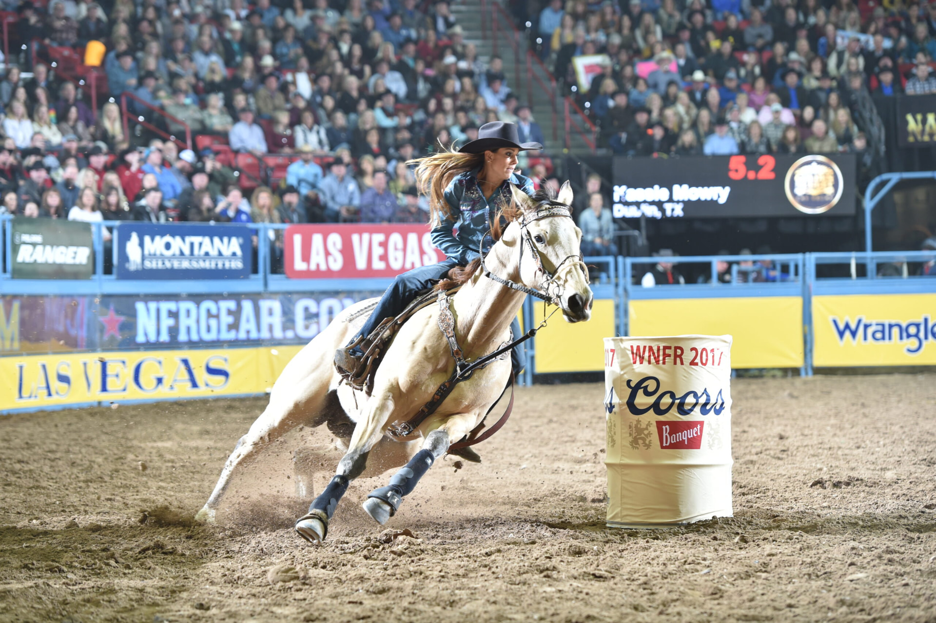Barrel racer rounding a barrel at the National Finals Rodeo in Las Vegas