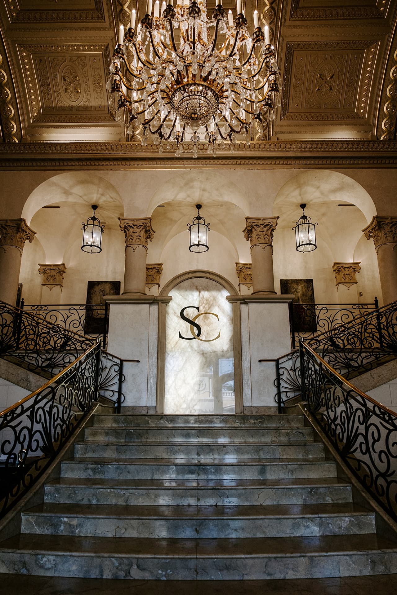 Grand marble staircase and chandelier inside The Stirling Club, Las Vegas